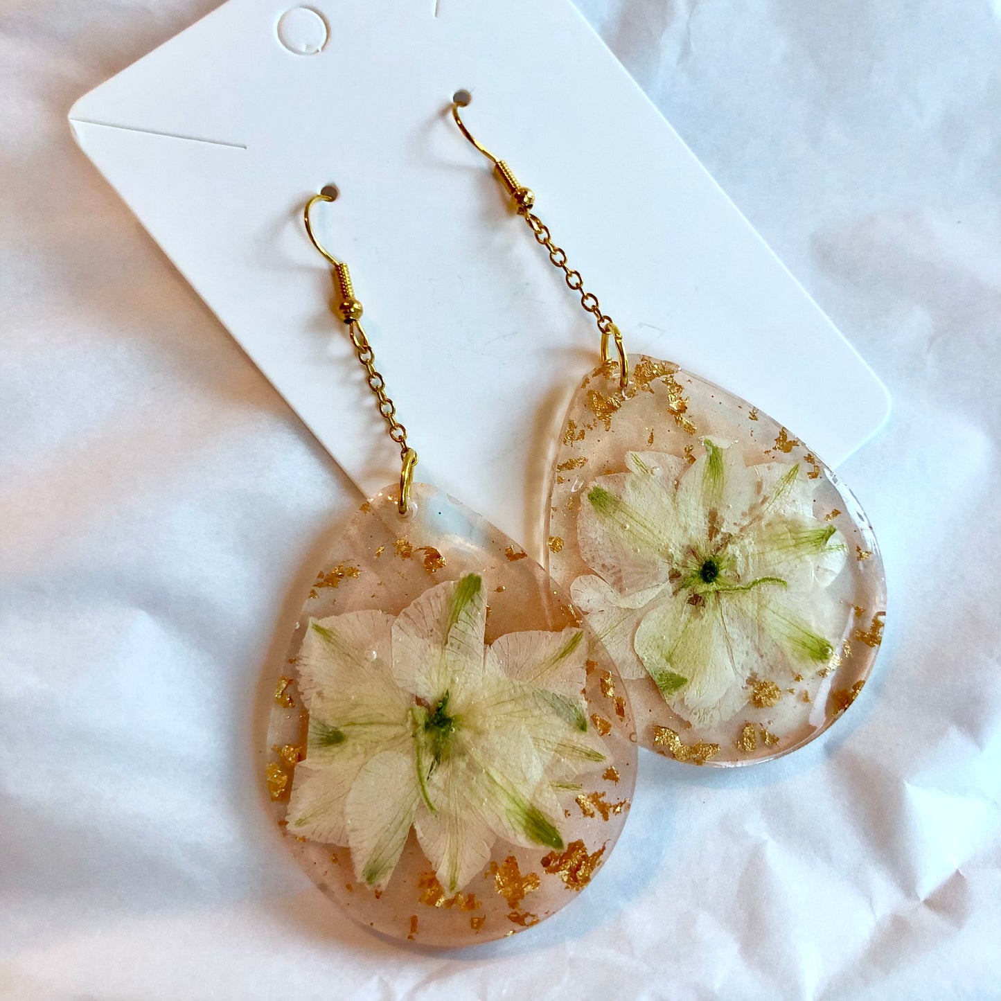 Beige color teardrop dangle earrings with white flower and gold inside. Large size.