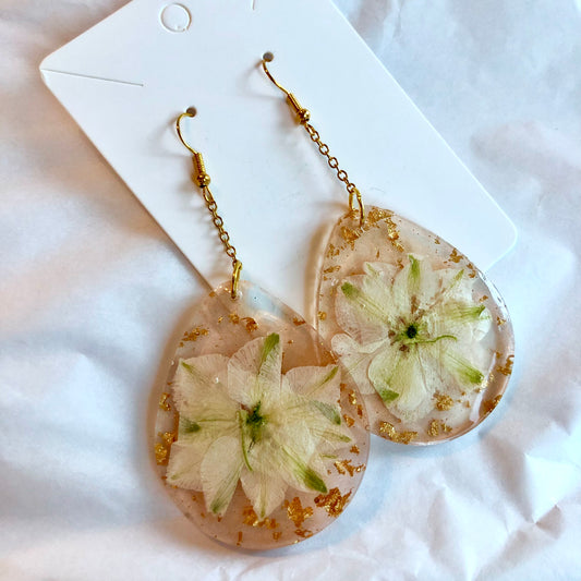Beige color teardrop dangle earrings with white flower and gold inside. Large size.