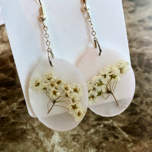 Lightest pink translucent ovals with white flowers. Medium size.