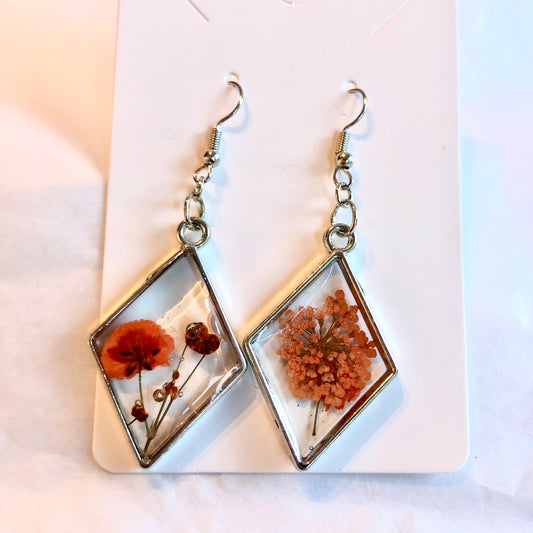 Silver diamond bezels with orange flowers inside. Medium size.